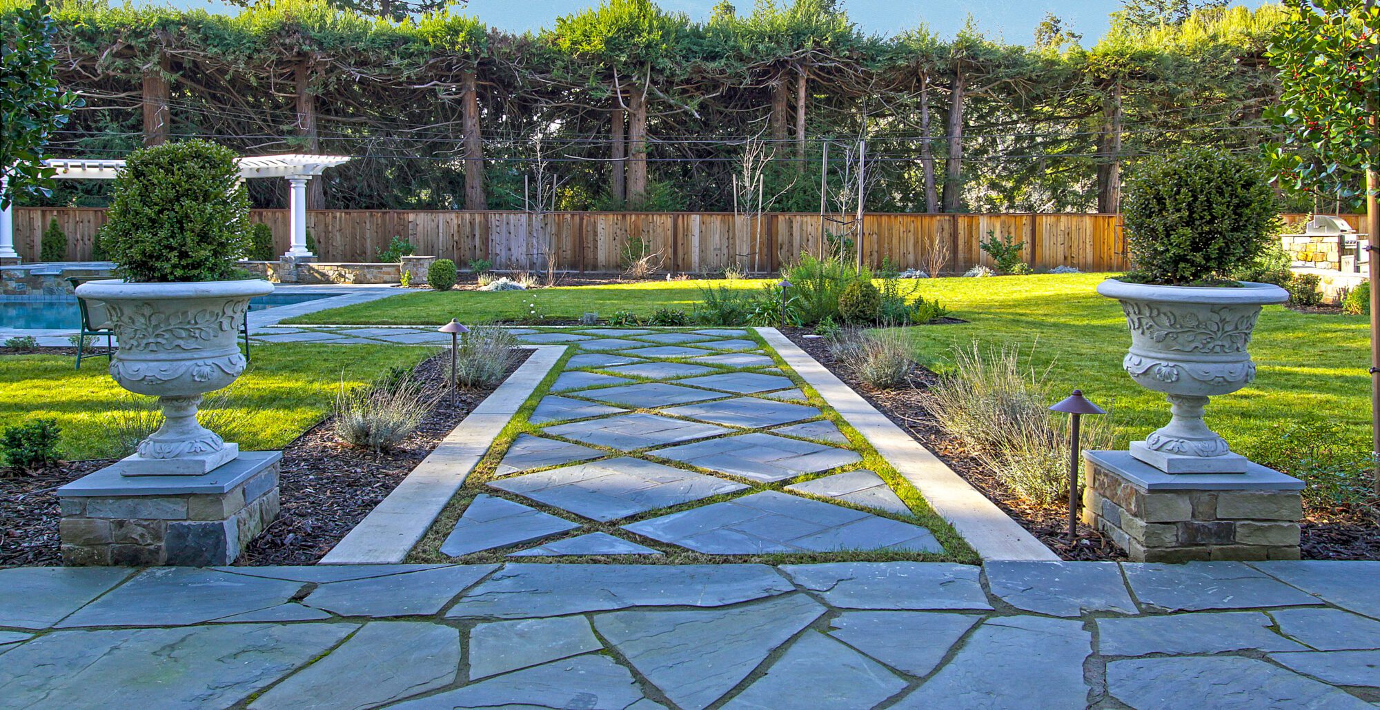 Paver walkway leading to backyard pool in Atherton landscape remodel